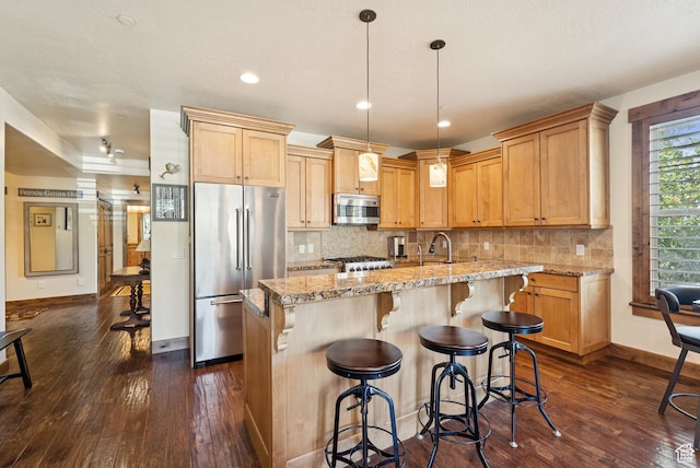 9855 Vista Dr Unit 103, Heber City, UT 84032 - kitchen featuring stainless steel appliances, dark wood-style floors, a center island with sink, tasteful backsplash, and recessed lighting