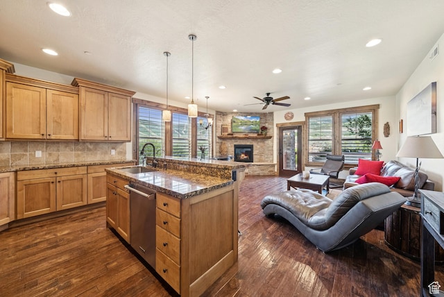 9855 Vista Dr Unit 103, Heber City, UT 84032 - kitchen featuring open floor plan, stainless steel dishwasher, a fireplace, dark wood-style floors, and recessed lighting