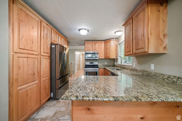 8916 S Cobble Crest Ln E, Sandy, UT 84093 - kitchen with appliances with stainless steel finishes, light stone counters, and a peninsula