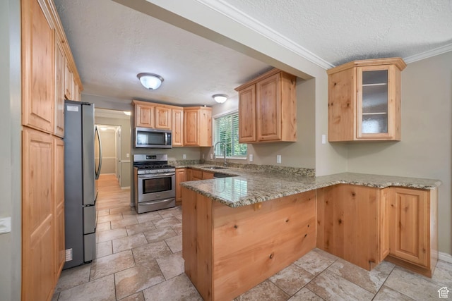 8916 S Cobble Crest Ln E, Sandy, UT 84093 - kitchen with stainless steel appliances, a peninsula, a textured ceiling, light stone finish floors, and light stone counters