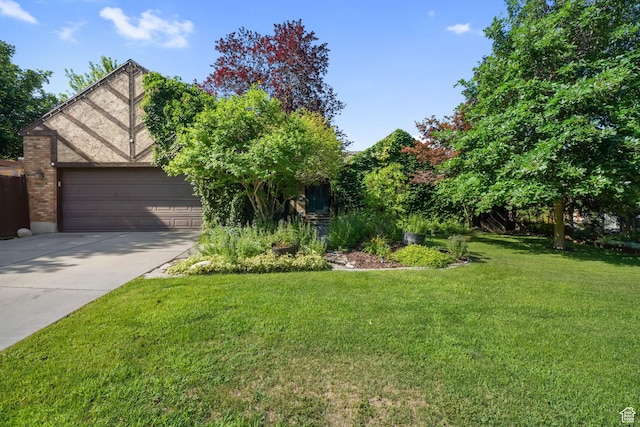 8916 S Cobble Crest Ln E, Sandy, UT 84093 - obstructed view of property featuring driveway, a garage, and a front lawn