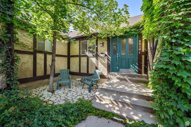 8916 S Cobble Crest Ln E, Sandy, UT 84093 - doorway to property with roof with shingles