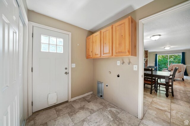 8916 S Cobble Crest Ln E, Sandy, UT 84093 - laundry room with cabinet space, hookup for an electric dryer, light stone finish floors, hookup for a washing machine, and gas dryer hookup
