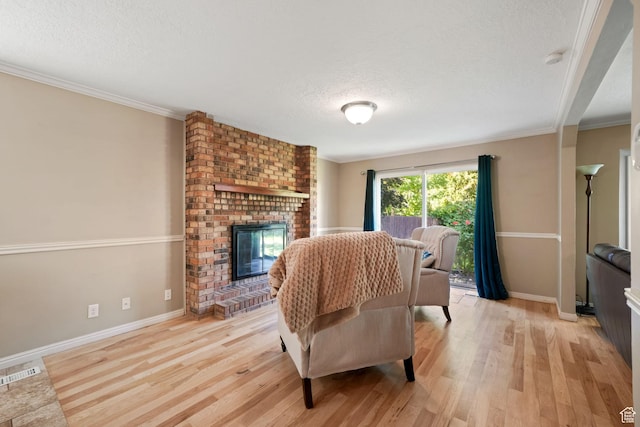 8916 S Cobble Crest Ln E, Sandy, UT 84093 - living room featuring light wood-style floors, a textured ceiling, a fireplace, and crown molding