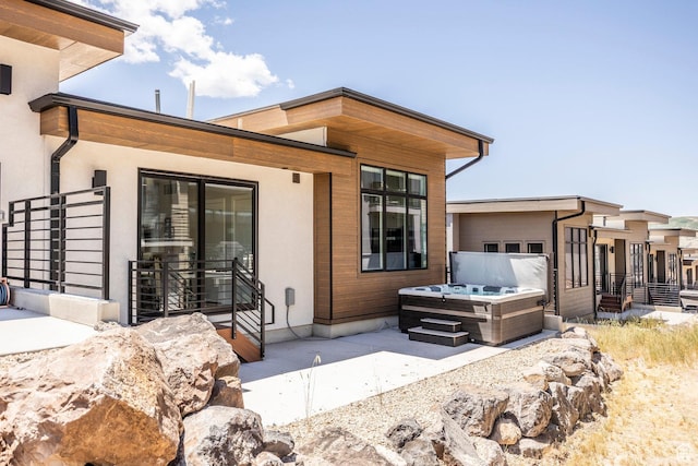 855 E Klaim Dr, Hideout, UT 84036 - back of property featuring a hot tub and a patio area
