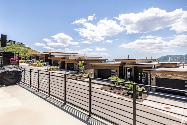 855 E Klaim Dr, Hideout, UT 84036 - view of front of house featuring a balcony, a mountain view, and an attached garage