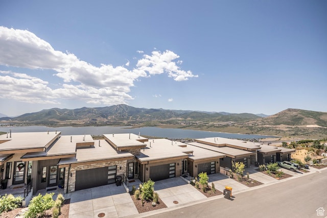 855 E Klaim Dr, Hideout, UT 84036 - view of front of house featuring driveway, a water and mountain view, and stone siding