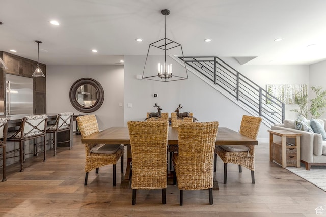 855 E Klaim Dr, Hideout, UT 84036 - dining space with light wood-style flooring, recessed lighting, a chandelier, and stairs