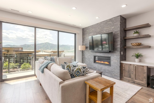 855 E Klaim Dr, Hideout, UT 84036 - living room with a fireplace, wood finished floors, and recessed lighting