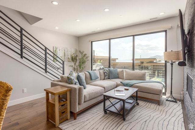 855 E Klaim Dr, Hideout, UT 84036 - living area featuring plenty of natural light, light wood-type flooring, recessed lighting, stairs, and a glass covered fireplace