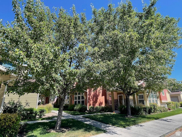 3794 W Angelica Ct, South Jordan, UT 84095 - view of property hidden behind natural elements featuring a front yard and brick siding