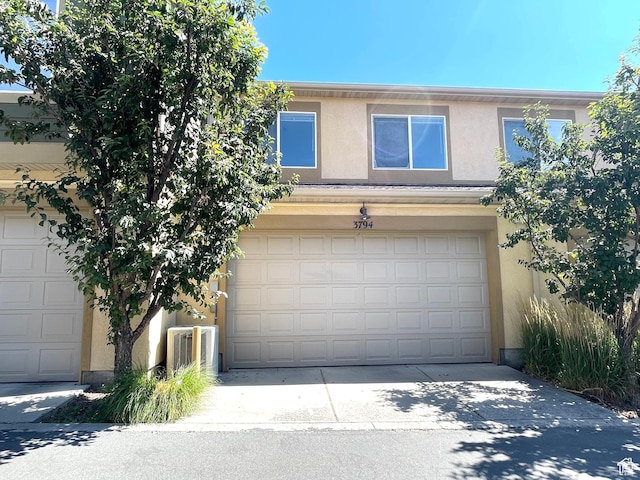 3794 W Angelica Ct, South Jordan, UT 84095 - view of front facade with stucco siding, a garage, and concrete driveway