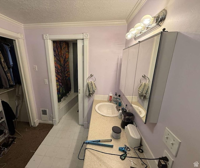 1012 W 3550 N, Pleasant View, UT 84414 - bathroom featuring a textured ceiling, vanity, and ornamental molding