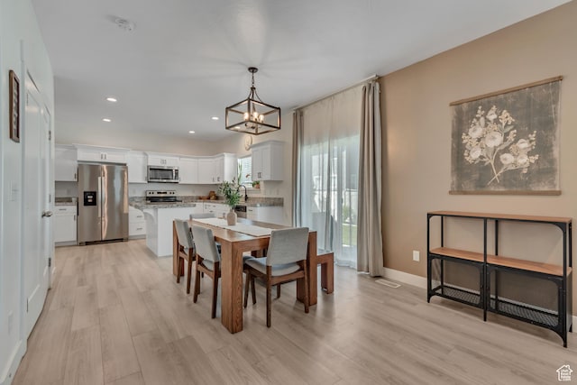 4913 E Golden Meadow Xing, Eagle Mountain, UT 84005 - dining room featuring a chandelier, light wood-type flooring, and recessed lighting