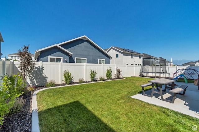 4913 E Golden Meadow Xing, Eagle Mountain, UT 84005 - fenced backyard featuring a trampoline and a patio area