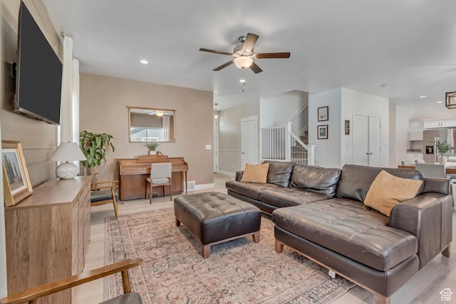 4913 E Golden Meadow Xing, Eagle Mountain, UT 84005 - living room with ceiling fan, stairway, light wood-style floors, and recessed lighting