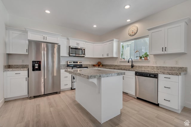 4913 E Golden Meadow Xing, Eagle Mountain, UT 84005 - kitchen featuring appliances with stainless steel finishes, light wood-style flooring, white cabinets, a center island, and recessed lighting