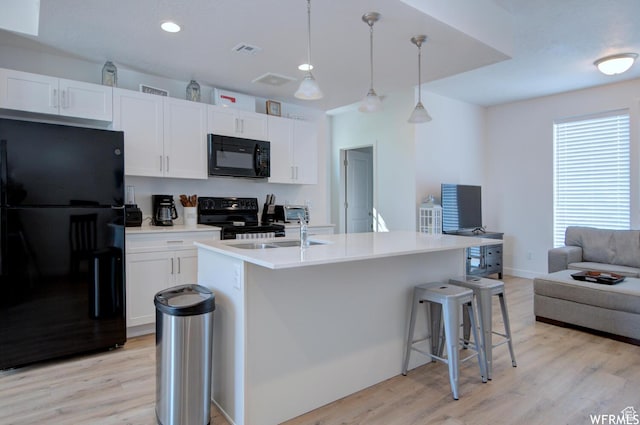 1690 S 225 W, Clearfield, UT 84015 - kitchen with black appliances, light wood-type flooring, open floor plan, white cabinetry, and recessed lighting