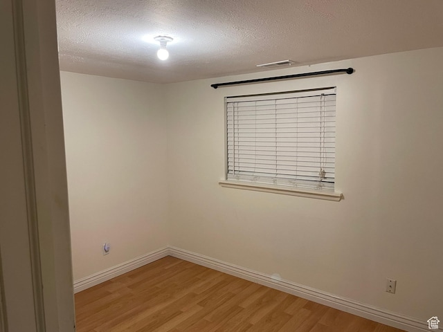 484 N 300 W, Logan, UT 84321 - empty room with light wood-style flooring and a textured ceiling
