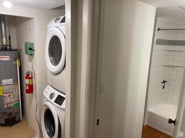 484 N 300 W, Logan, UT 84321 - washroom with water heater and stacked washing machine and dryer