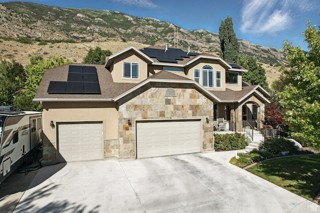 9116 Silver Lake Dr, Cedar Hills, UT 84062 - view of front of house with stone siding, solar panels, stucco siding, concrete driveway, and a mountain view