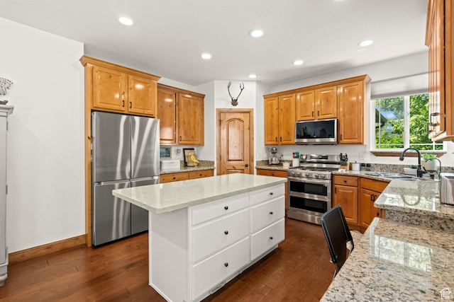 9116 Silver Lake Dr, Cedar Hills, UT 84062 - kitchen featuring appliances with stainless steel finishes, a center island, dark wood-style flooring, light stone counters, and recessed lighting