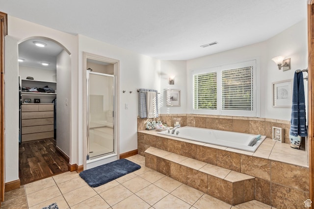 9116 Silver Lake Dr, Cedar Hills, UT 84062 - full bathroom featuring a shower stall, a walk in closet, a bath, and tile patterned flooring