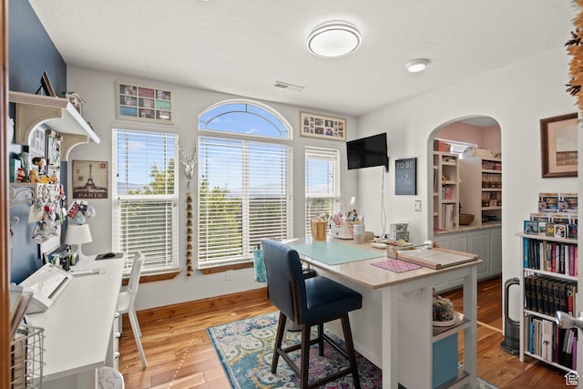 9116 Silver Lake Dr, Cedar Hills, UT 84062 - office with arched walkways, light wood-type flooring, and a textured ceiling