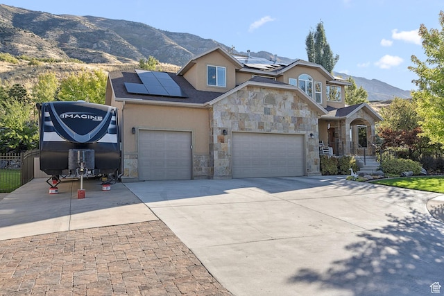9116 Silver Lake Dr, Cedar Hills, UT 84062 - traditional home featuring stone siding, stucco siding, a mountain view, solar panels, and driveway