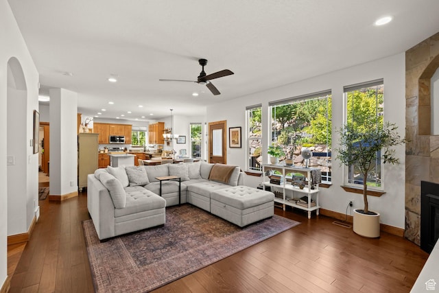 9116 Silver Lake Dr, Cedar Hills, UT 84062 - living room featuring dark wood-type flooring, recessed lighting, ceiling fan, plenty of natural light, and arched walkways