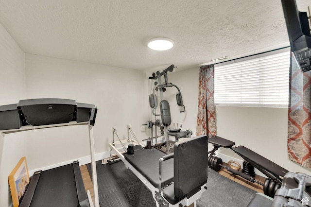 1609 N 2275 W, Clinton, UT 84015 - workout area featuring a textured ceiling and wood finished floors