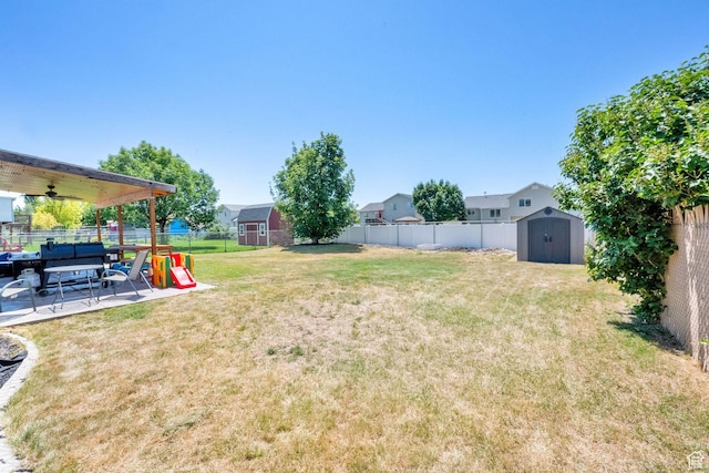 1609 N 2275 W, Clinton, UT 84015 - fenced backyard featuring a storage unit, a ceiling fan, and a patio area
