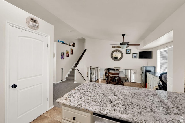 1609 N 2275 W, Clinton, UT 84015 - kitchen with ceiling fan, light stone counters, lofted ceiling, light tile patterned flooring, and white cabinets