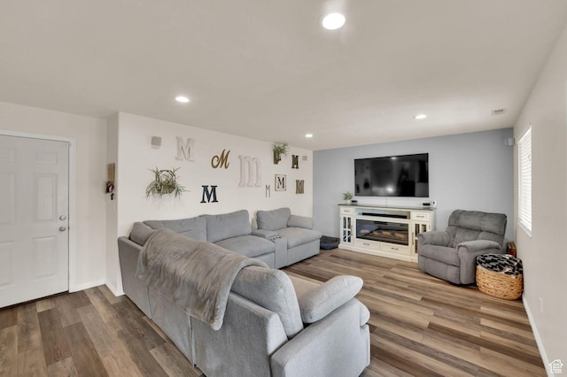 1609 N 2275 W, Clinton, UT 84015 - living area featuring dark wood-type flooring, recessed lighting, and a glass covered fireplace