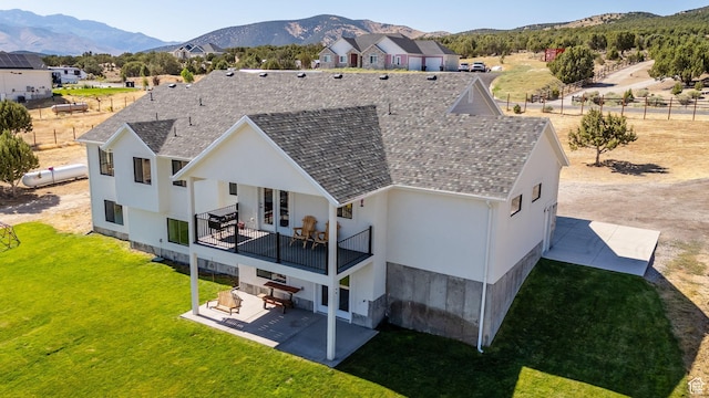 2423 W Cedarline Loop, Stockton, UT 84071 - back of property featuring a patio, a lawn, a mountain view, and stucco siding