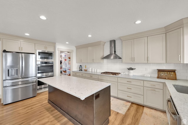 2423 W Cedarline Loop, Stockton, UT 84071 - kitchen with stainless steel appliances, wall chimney exhaust hood, light wood-type flooring, a kitchen island, and tasteful backsplash
