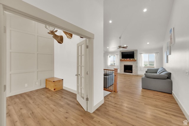 2423 W Cedarline Loop, Stockton, UT 84071 - living room featuring a fireplace, light wood-type flooring, ceiling fan, recessed lighting, and a towering ceiling
