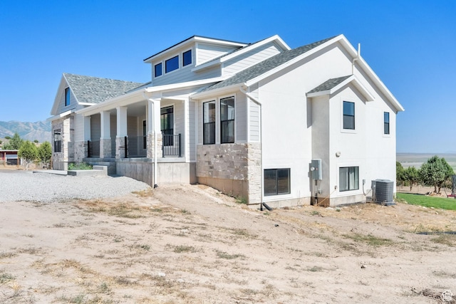 2423 W Cedarline Loop, Stockton, UT 84071 - view of front facade featuring covered porch, stone siding, and a shingled roof