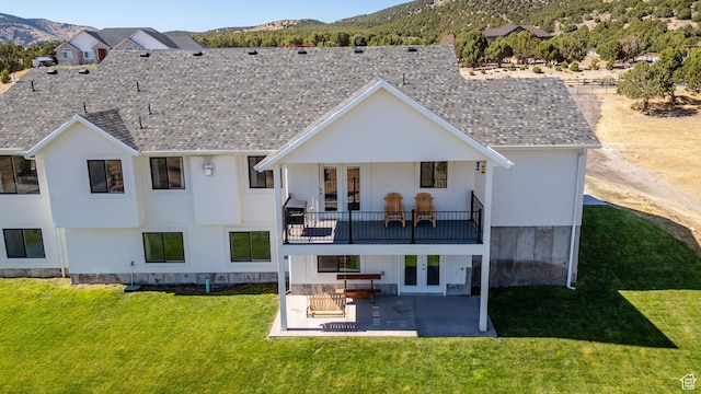 2423 W Cedarline Loop, Stockton, UT 84071 - rear view of property featuring french doors, a mountain view, a patio area, and a lawn