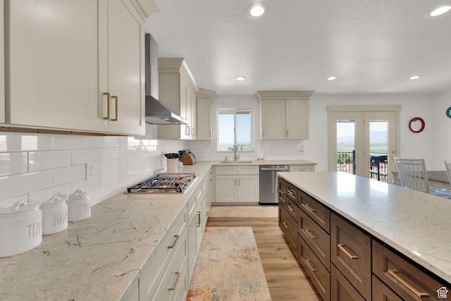 2423 W Cedarline Loop, Stockton, UT 84071 - kitchen with appliances with stainless steel finishes, wall chimney exhaust hood, light wood finished floors, backsplash, and recessed lighting