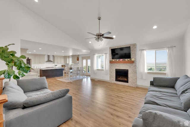 2423 W Cedarline Loop, Stockton, UT 84071 - living room with recessed lighting, ceiling fan, a stone fireplace, light wood finished floors, and high vaulted ceiling