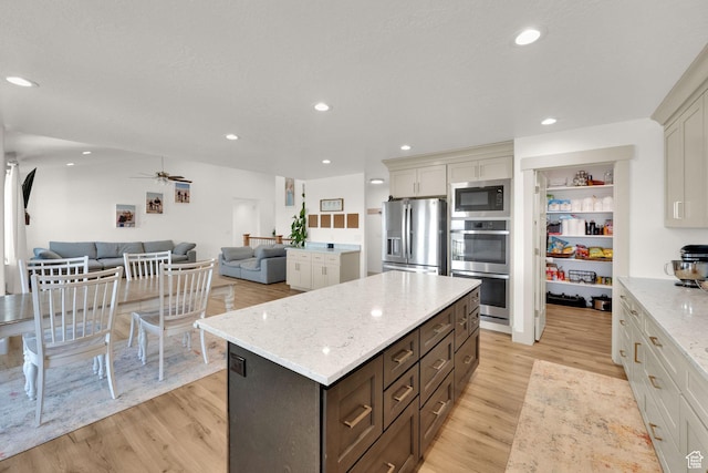 2423 W Cedarline Loop, Stockton, UT 84071 - kitchen featuring stainless steel appliances, open floor plan, light wood-style flooring, a kitchen island, and recessed lighting