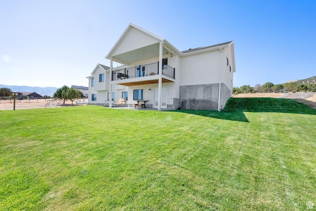 2423 W Cedarline Loop, Stockton, UT 84071 - rear view of house featuring a balcony, a yard, a patio area, and stucco siding