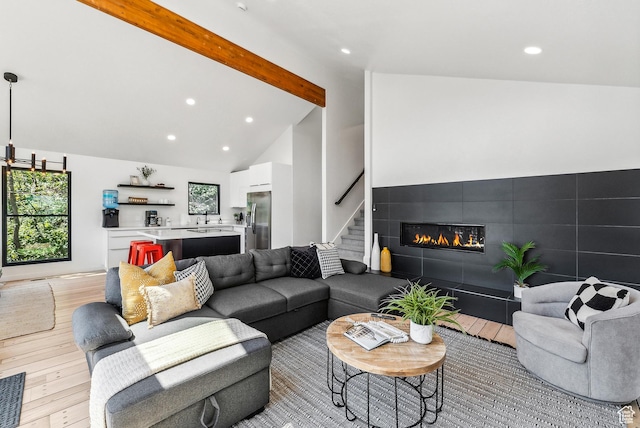 947 Northstar Dr, Park City, UT 84060 - living room with light wood-style floors, beam ceiling, a tiled fireplace, stairs, and recessed lighting