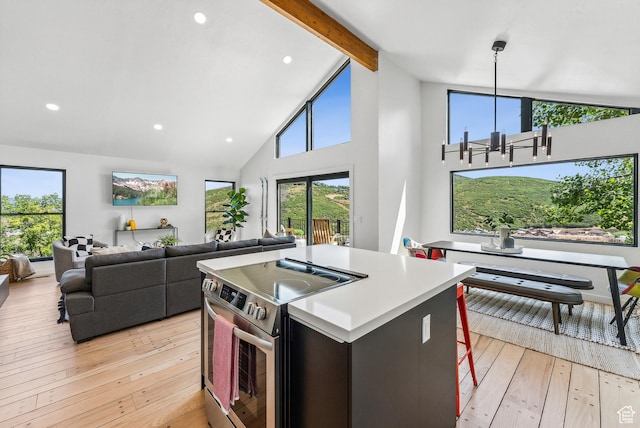947 Northstar Dr, Park City, UT 84060 - kitchen featuring stainless steel electric stove, light wood-type flooring, beam ceiling, a kitchen island, and high vaulted ceiling