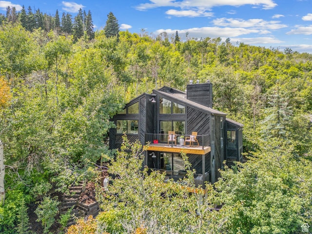 947 Northstar Dr, Park City, UT 84060 - rear view of house featuring a chimney, a wooded view, and a wooden deck