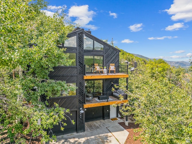 947 Northstar Dr, Park City, UT 84060 - rear view of property with concrete driveway, a sunroom, and a deck with mountain view