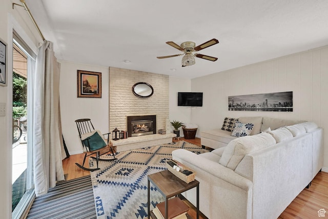 4445 Fillmore Ave, Ogden, UT 84403 - living area with a ceiling fan, wood finished floors, and a brick fireplace