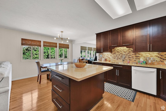 4445 Fillmore Ave, Ogden, UT 84403 - kitchen featuring white dishwasher, light wood-style flooring, and tasteful backsplash