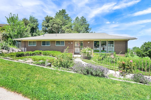 4445 Fillmore Ave, Ogden, UT 84403 - single story home with brick siding and a front lawn